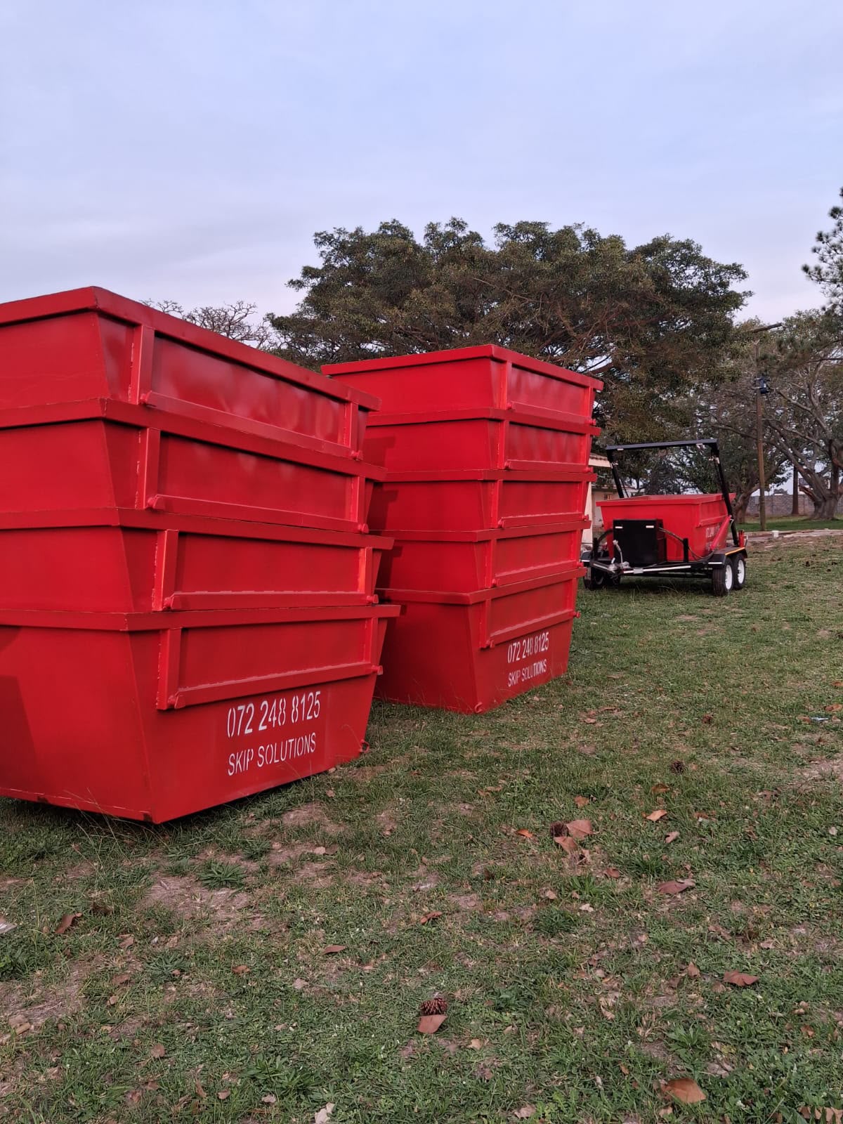 Multiple red Skip Solutions skips for custom or monthly hire